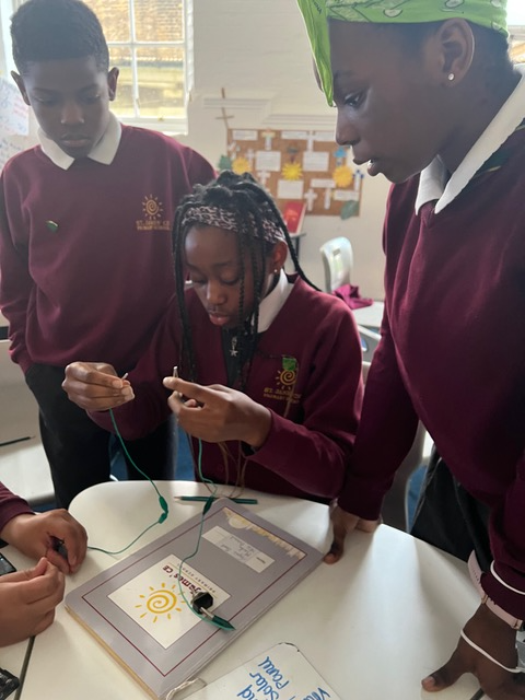 Some children in class documenting their scientific experiment.